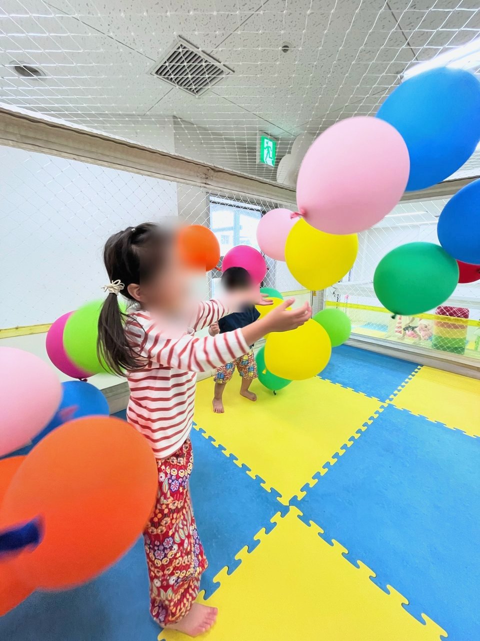 たくさんの風船の中で遊ぶ子ども